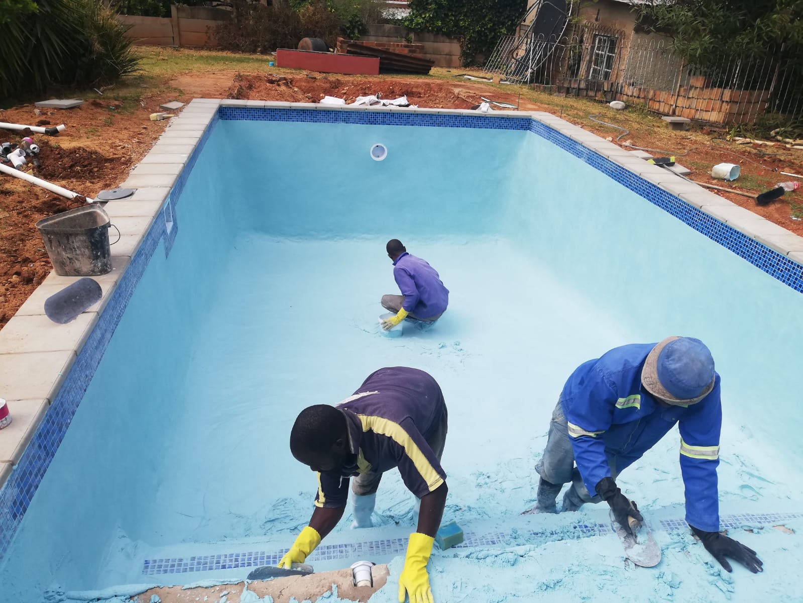 Team applying pool surface coating